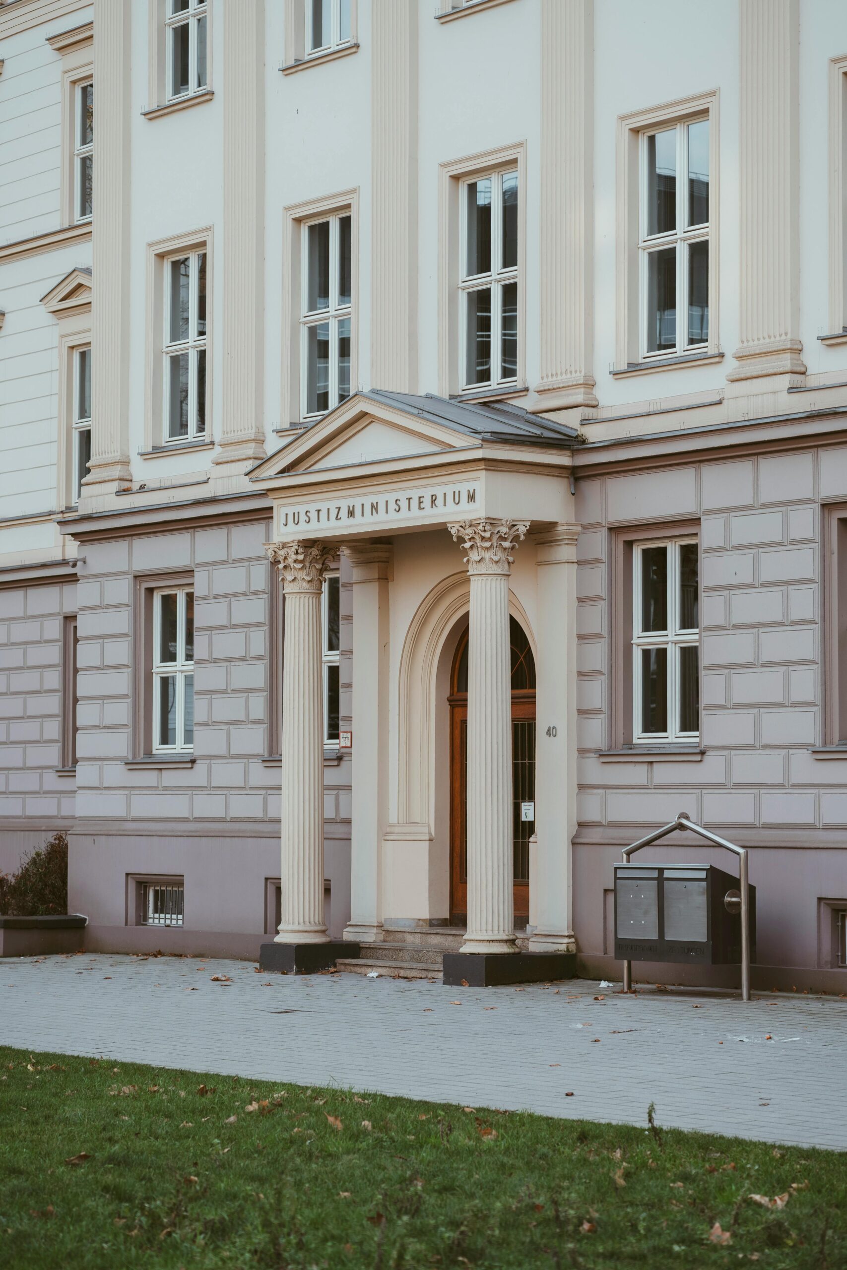 Elegant neoclassical facade of a German justice ministry building with columns and entrance.